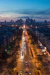 Magnificent look from Arc de Triomphe (Triumphal Arc) towards the La défense at sunset - the parisien trade quarter, the streets are lighten by the cars and street lamps