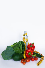 Healthy eating, dieting, slimming and weigh loss concept. Vegetables, water and measuring tape on...