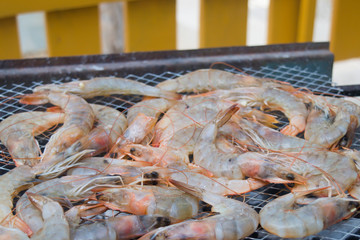 Roasted tiger prawns on metal baking sheet background close up