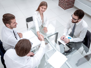 handshake business partners sitting at the office Desk