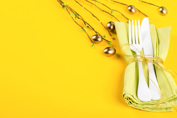 Easter table setting with  Kitchen cutlery on a bright yellow background. Holiday decoration.Happy Easter concept. Top View. Flat Lay.Copy space for Text.