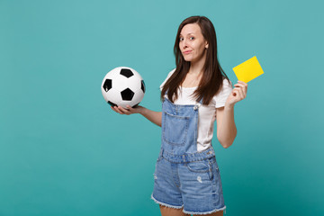 Perplexed young woman football fan support team with soccer ball yellow card propose player retire...