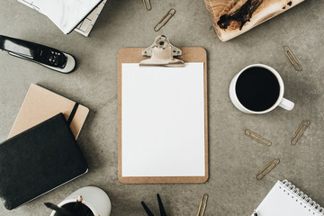 Flat lay of clipboard with copy space blank mock up. Top view home office desk workspace decorated...