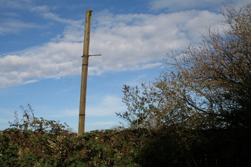 old pylon with clouds