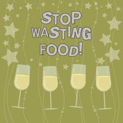 Text sign showing Stop Wasting Food. Conceptual photo organization works for reduction food waste in society Filled Cocktail Wine Glasses with Scattered Stars as Confetti Stemware