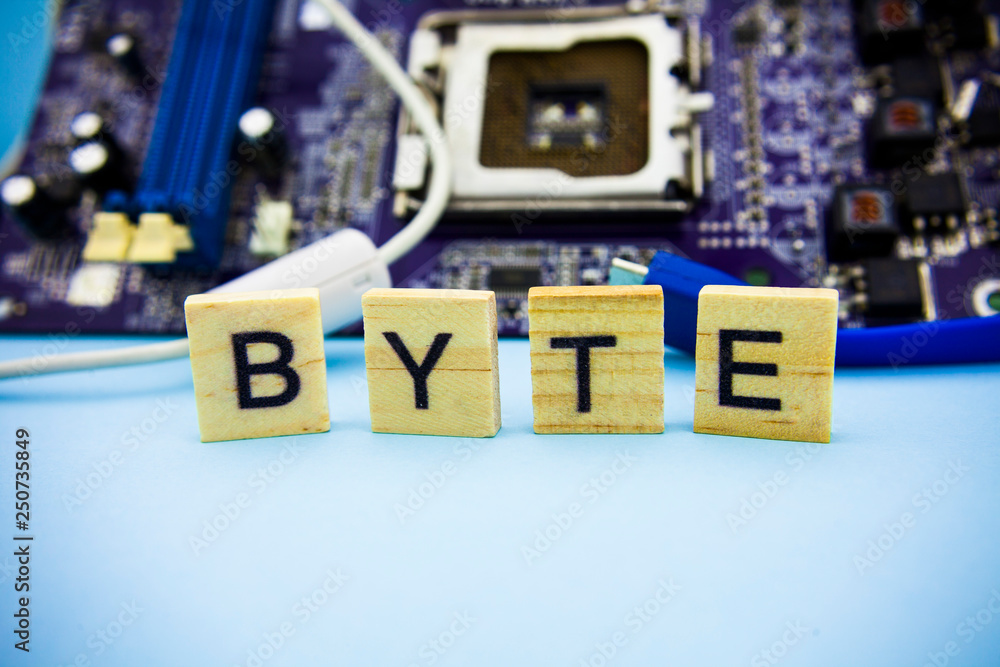 Fototapete word byte on the wooden blocks with computers mainboard background. information technology backgroun