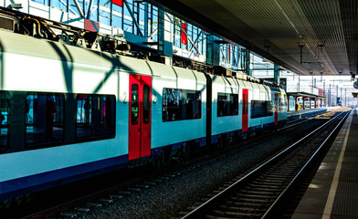 Naklejka premium Train on the station waiting for passengers. Electric train with passengers. Travel and tourism conceptual image