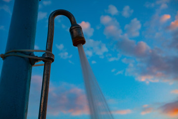 Public shower on the beach. Water Pouring from Shower Head