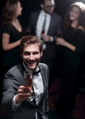 stylish young man raising a glass of wine