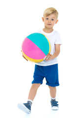 A little boy is playing with a ball.