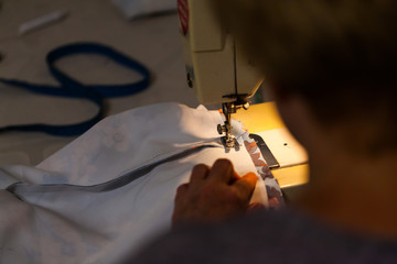 Women's hands on the sewing machine. Industry concept with creating clothes