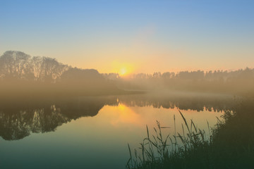Fototapeta premium river landscape, misty evening