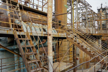 Old Factory metal structures. Industrial plant with old, rusty pipes and cooling tower for cooling water supply. Beijing, China.