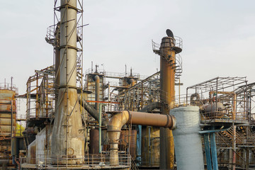 Old Factory metal structures. Industrial plant with old, rusty pipes and cooling tower for cooling water supply. Beijing, China.