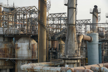 Old Factory metal structures. Industrial plant with old, rusty pipes and cooling tower for cooling water supply. Beijing, China.