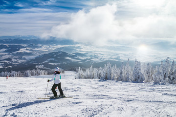 Naklejka na ściany i meble Beautiful scenery of the snowy winter landscape. View from the ski slope of the Kubinska hola resort in Slovakia, Europe.
