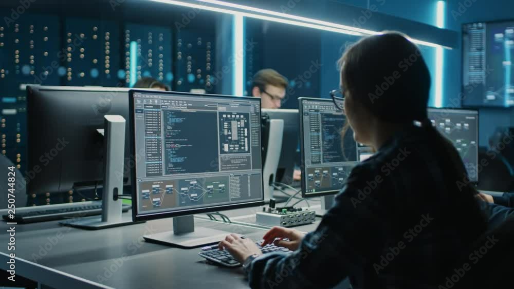 Poster Smart Female IT Programer Working on Desktop Computer in Data Center System Control Room. Team of Young Professionals Doing Code Programming