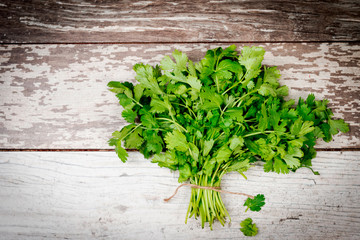bunch of parsley on wooden table