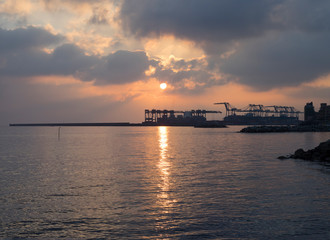 Fototapeta na wymiar sihlouette of Big port cranes at sunset