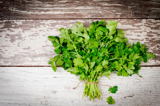 bunch of parsley on wooden table
