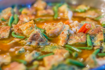 Spicy curry sour with omelet mixed Climbing Wattle. Delicious traditional Thai food, spicy sour soup curry with Shrimp and omelet mixed Climbing Wattle (Kaeng som khai cha-om)