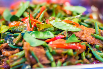 Stir-fried pork with chili paste, bergamot leaves, and yardlong bean. Beef stir fried with variety of vegetables for serve in the buffet party in the restaurant.