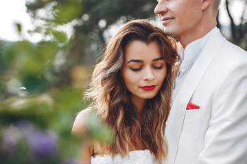 Beautiful wedding couple in a summer field