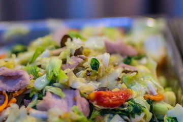 Pork stir fried with variety of vegetables for serve in the buffet party in the restaurant.