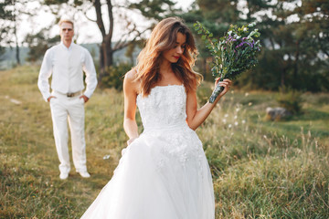 Beautiful wedding couple in a summer field