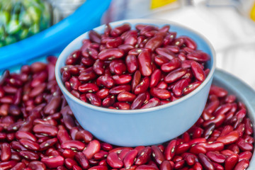 Red kidney beans with measure out bowl for sale in the market. Kidney bean is a variety of the common bean (Phaseolus vulgaris). It is named for its visual resemblance in shape and colour to a kidney.