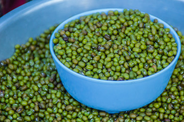 Mung bean with measure out bowl for sale in the market. The mung bean (Vigna radiata) also known as moong bean, monggo, green gram, or mung. It is used as an ingredient in both savory and sweet dishes