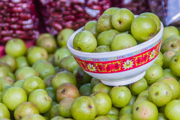 Indian gooseberry (Phyllanthus emblica), also known as emblic, emblic myrobalan, myrobalan, Indian gooseberry, Malacca tree, or amla fruit. Emblic fruits for sale in the fruit market, Thailand.