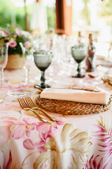 Elegant cutlery and floral arrangements for a table in a wedding restaurant with vintage style centerpieces.
