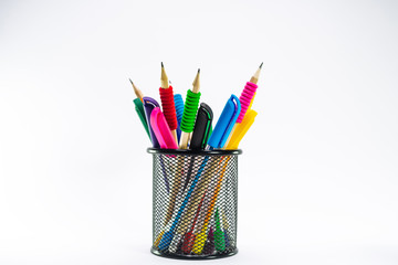 Colored pencils in a pencil case on white background