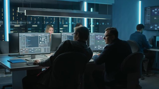 Team of IT Programers Working on Desktop Computers in Data Center Control Room. Team of Young Professionals Working In Software and Hardware Development, Doing Coding 