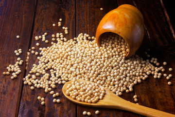 raw and fresh soy beans inside wooden bowl on rustic wooden table. Closeup