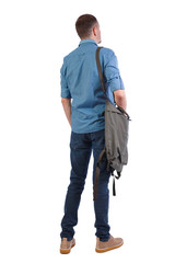 Back view of a man with a green bag.