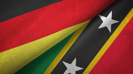 Fototapeta premium Germany and Saint Kitts and Nevis two flags textile cloth, fabric texture