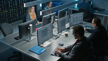 Team of IT Programers Working on Desktop Computers in Data Center System Control Room. Team of Young Professionals Working In Software and Hardware Development, Doing Coding. Elevated Camera Shot 
