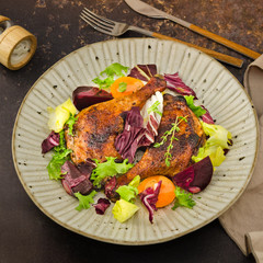 Roasted duck leg. Roasted christmas duck leg with green salad, beetroot and carrot