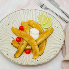 Baked caramelized bananas. Homemade sauteed bananas foster. Typical cuban dish - fried sliced banana. Ripe fried plantain - traditional dish in Central America 