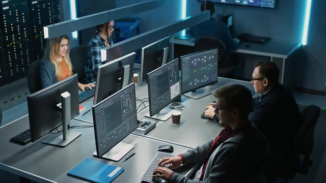 Team of IT Programers Working on Desktop Computers in Data Center System Control Room. Team of Young Professionals Working In Software and Hardware Development, Doing Coding 