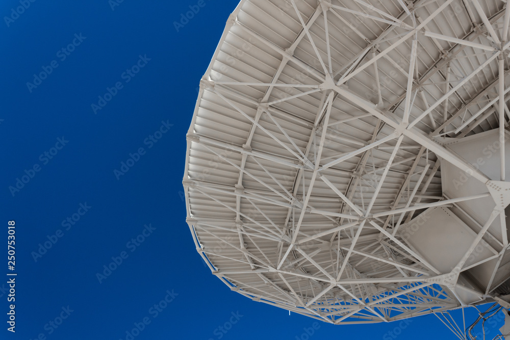 Wall mural very large array engineering understructure of a very large radio telescope dish against a vivid blu