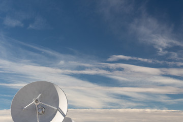 Very Large Array front view of radio astronomy observatory dish in clouds, science technology space, horizontal aspect