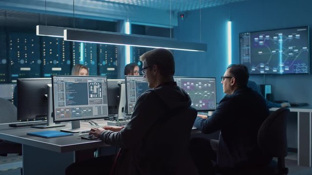 Team of IT Programers Working on Desktop Computers in Data Center System Control Room. Team of Young Professionals Working In Software and Hardware Development, Doing Coding 