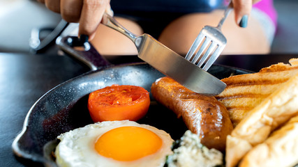 English breakfast: fried egg, bacon, sausage and toast in pan.