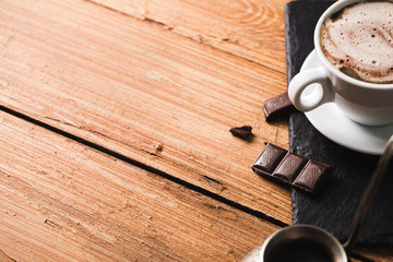 Black coffee with milk flatlay view on wooden background