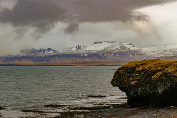Typical Icelandic sunrise sunset cliff landscape at Arnarstapi area in Snaefellsnes peninsula in Iceland