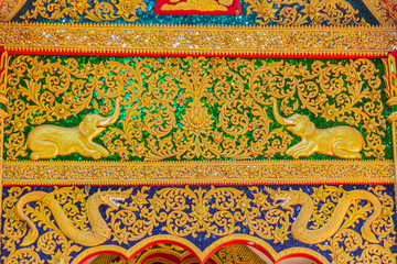 Beautiful golden craving on the entrance gable of the church at Wat Phra That Doi Tung, one of...