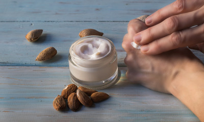 Human hand smearing cream of almonds
